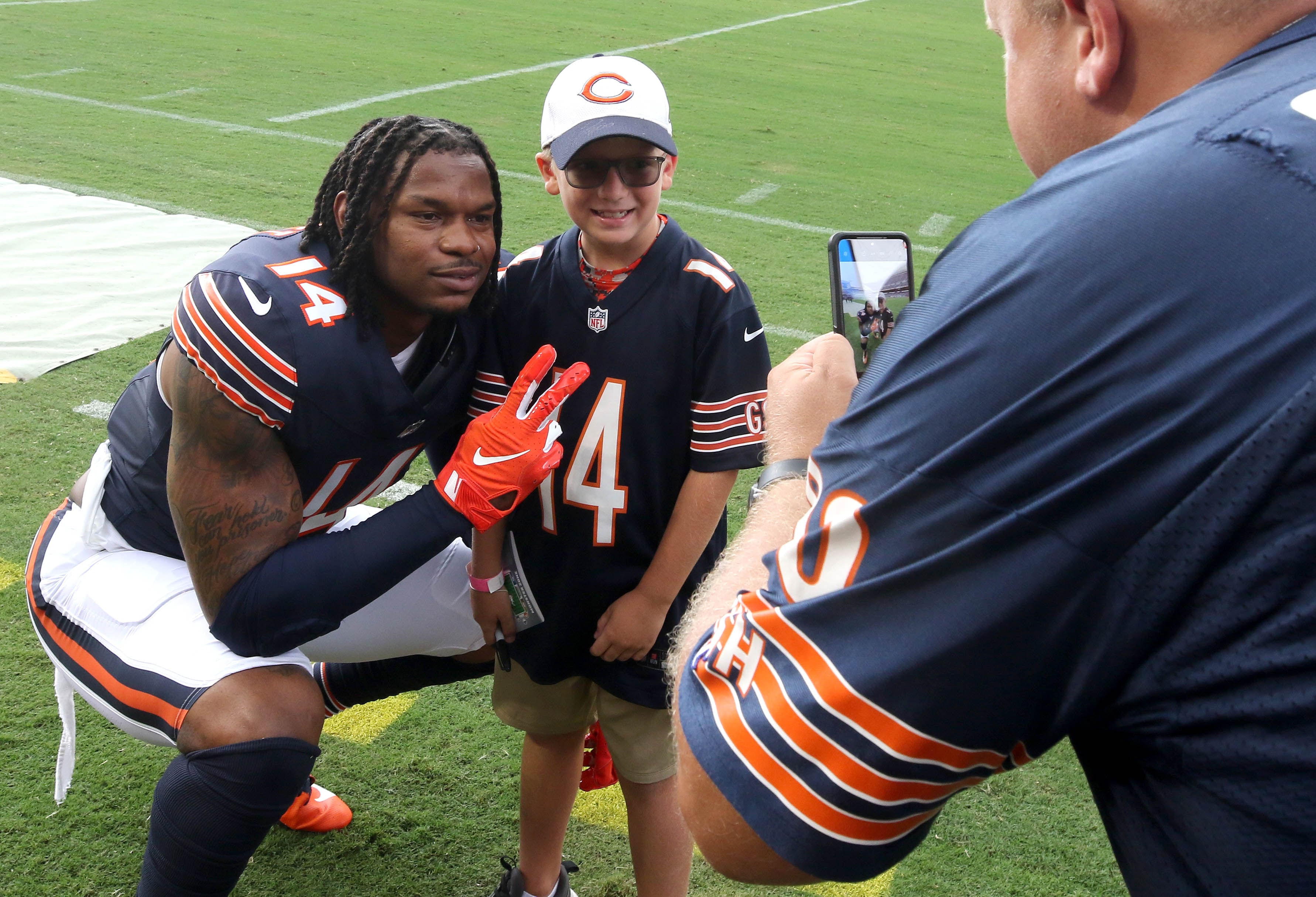 Chicago Bears tight end Gerald Everett takes a photo with a fan before their game with the Cincinnati Bengals Saturday, Aug. 17, 2024, at Soldier Field in Chicago.