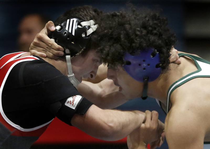 Marian Central's Max Astacio tries to take down St. Patrick's Giovanni Hernandez in their 106-pound wrestling match Thursday, Jan. 19, 2023, at Marian Central High School in Woodstock.