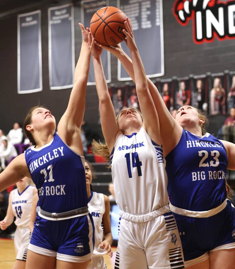 Newark’s Addison Long grabs a rebound between Hinckley-Big Rock's Raven Wagner (left) and Sami Carlino Thursday, Jan. 18, 2024, during the Little 10 girls basketball tournament at Indian Creek High School in Shabbona.