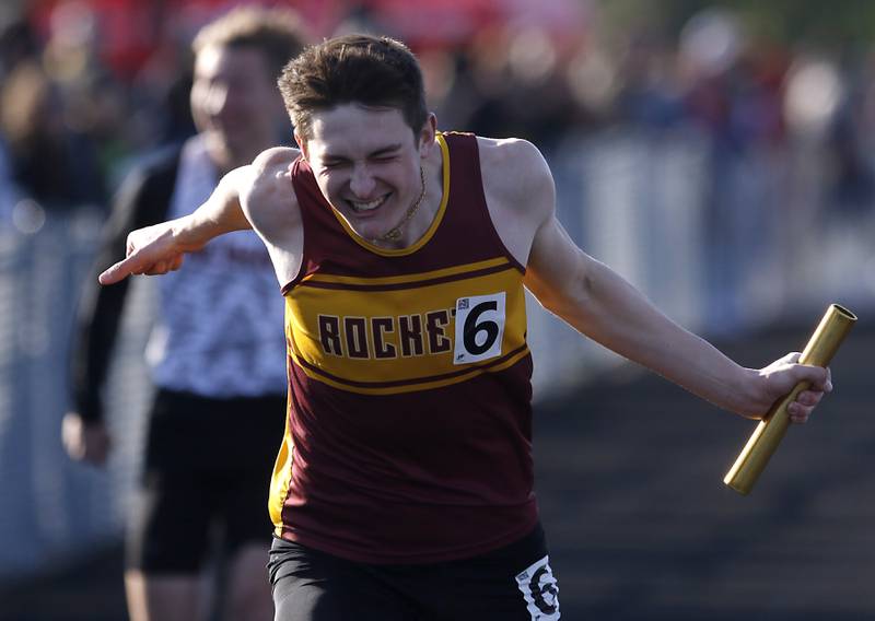 Richmond-Burton’s Sean Rockwell leans across the finish line to win the 4x100 meter relay Friday, April 21, 2023, during the McHenry County Track and Field Meet at Cary-Grove High School.