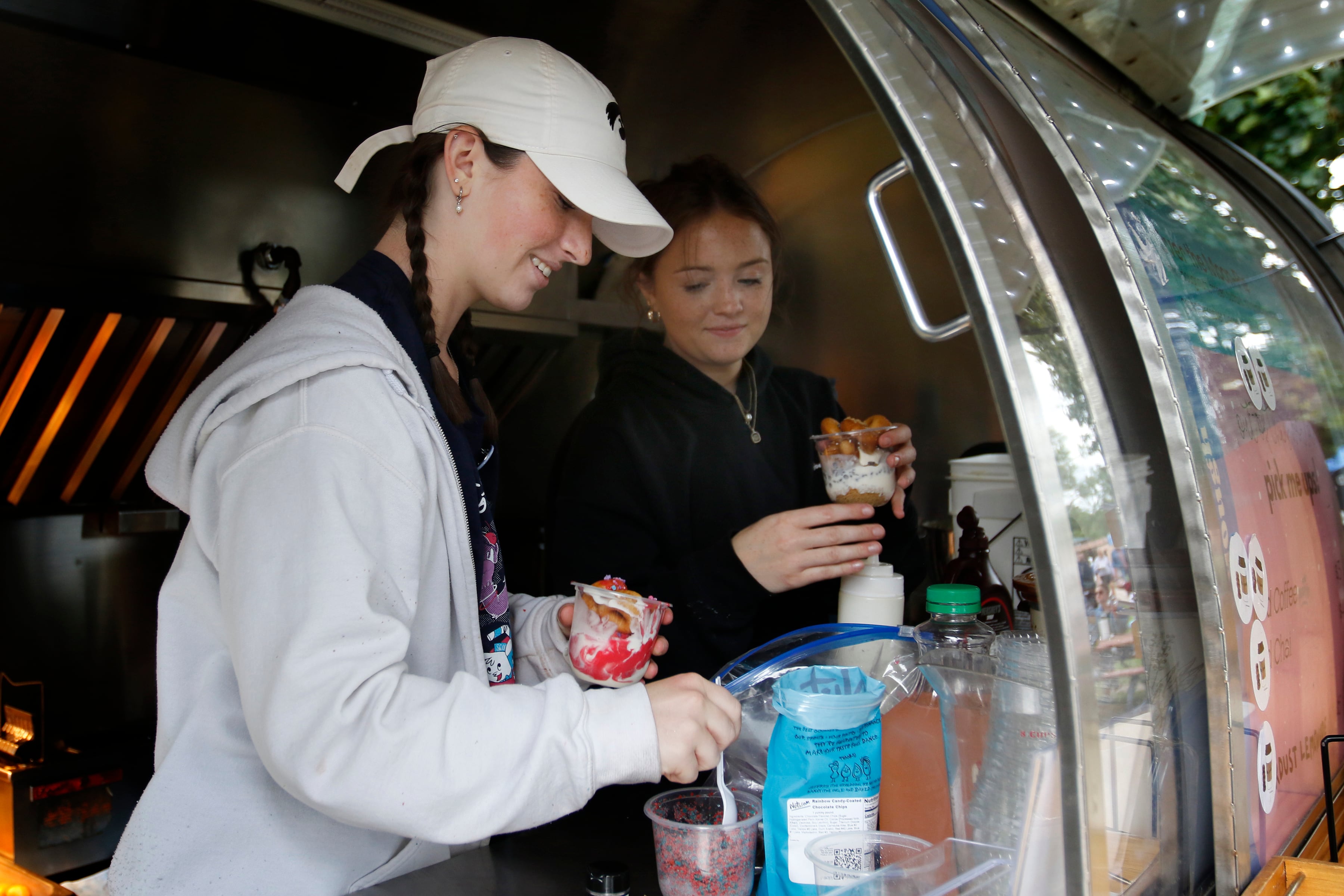 Abby Kirk and Kennedy Market make  sundaes at Joe & Dough during the Ice Cream Fest on Friday, Aug. 9, 2024, at Crystal Lake’s Main Beach. The second annual event featured music, ice cream venders and an ice cream eating contest.