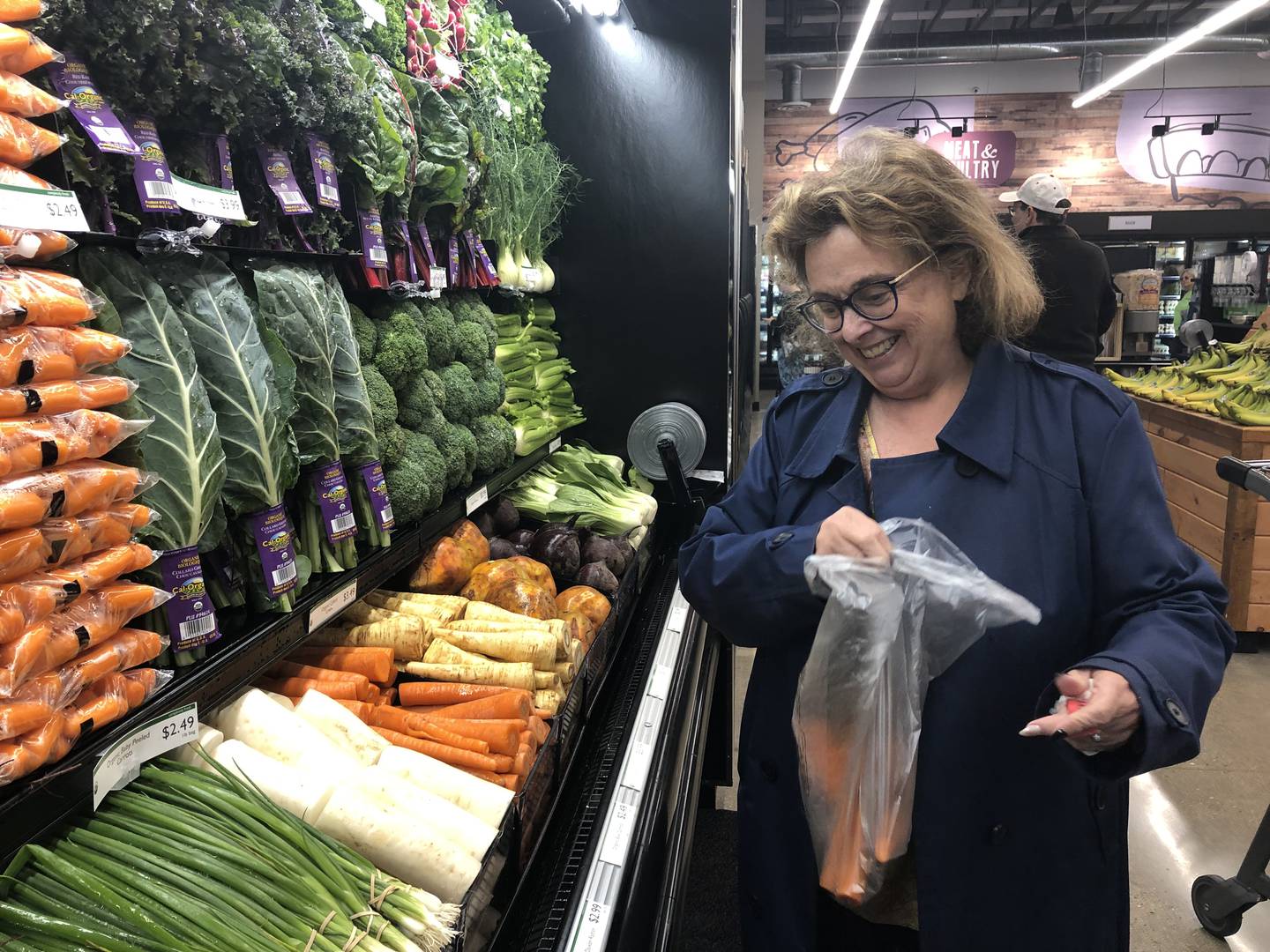 Tina Hill picks out produce at the Food Shed Co-op grand opening in Woodstock May 15, 2024.