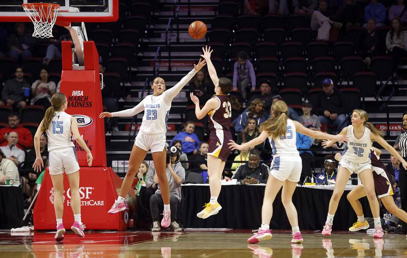 Nazareth Academy's Danielle Scully (23) attempts to block a shot by Loyola Academy's Paige Engels (33) during the IHSA Class 4A Girls Basketball championship game Saturday, March 2, 2024 at the CEFCU Arena in Normal.