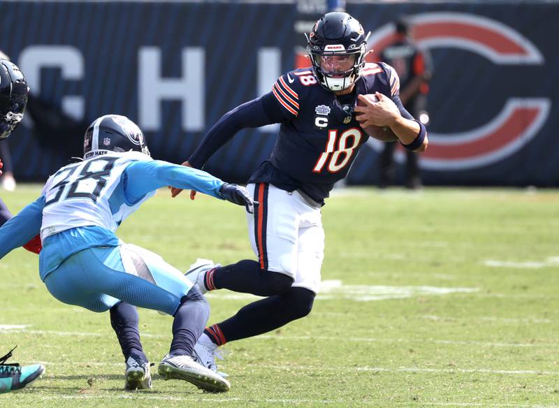 Chicago Bears quarterback Caleb Williams puts a move on Tennessee Titans cornerback L'Jarius Sneed during their game Sunday, Sept. 8, 2024, at Soldier Field in Chicago.