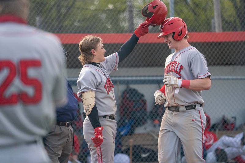 Yorkville's Kam Yearsley (left) greets Nate Harris (right) at home plate after Harris hits a homer against West Aurora during a baseball game at West Aurora High School on Monday, April 24, 2023.