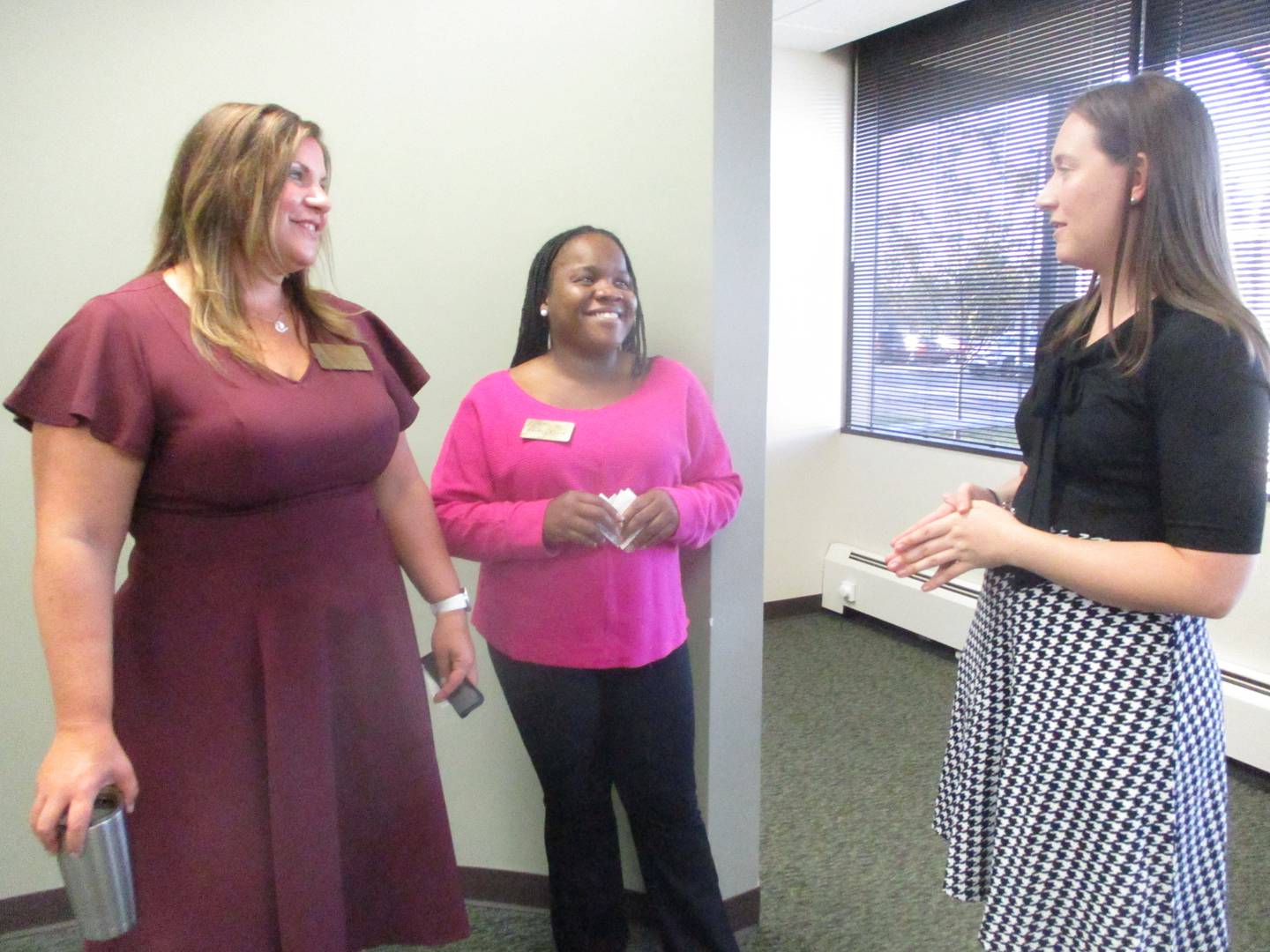 Joliet Township High School Superintendent Karla Guseman, left, and Shelley Clark, director of strategic partnerships for the school district, discuss a new internship program with Kayla Sorensen, director of investor relations for the Will County Center for Economic Development.