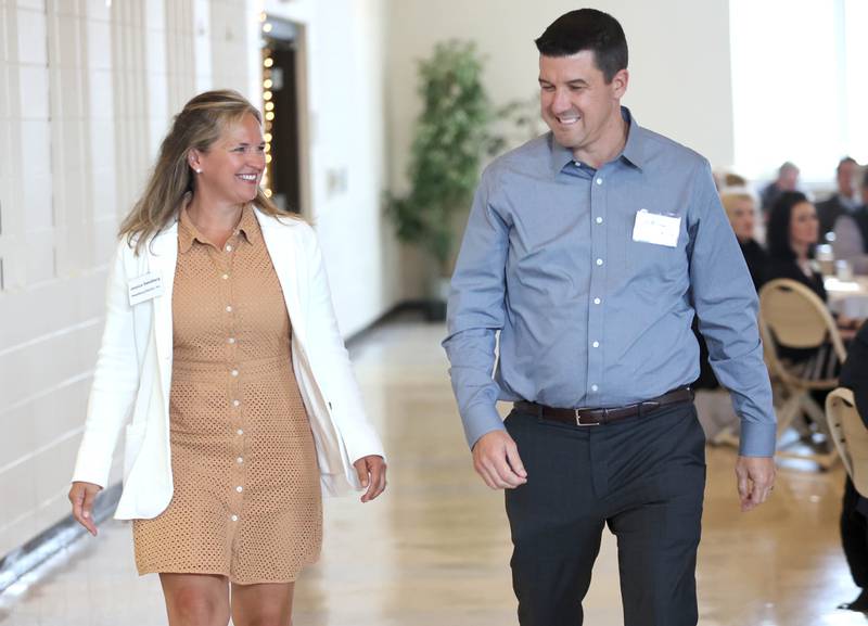 Jim and Jessica Swedberg of Swedberg Electric walk up to accept the Chamber Champion award during the annual meeting of the Sycamore Chamber of Commerce Thursday, April 7, 2022, at St. Mary Memorial Hall in Sycamore.