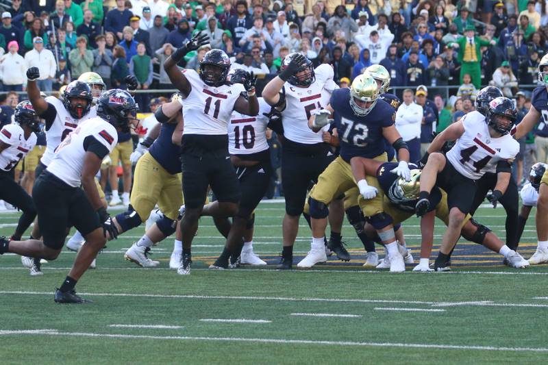 Members of the NIU football team react after beating Notre Dame on Saturday, Sept. 7, 2024 at Notre Dame Stadium.