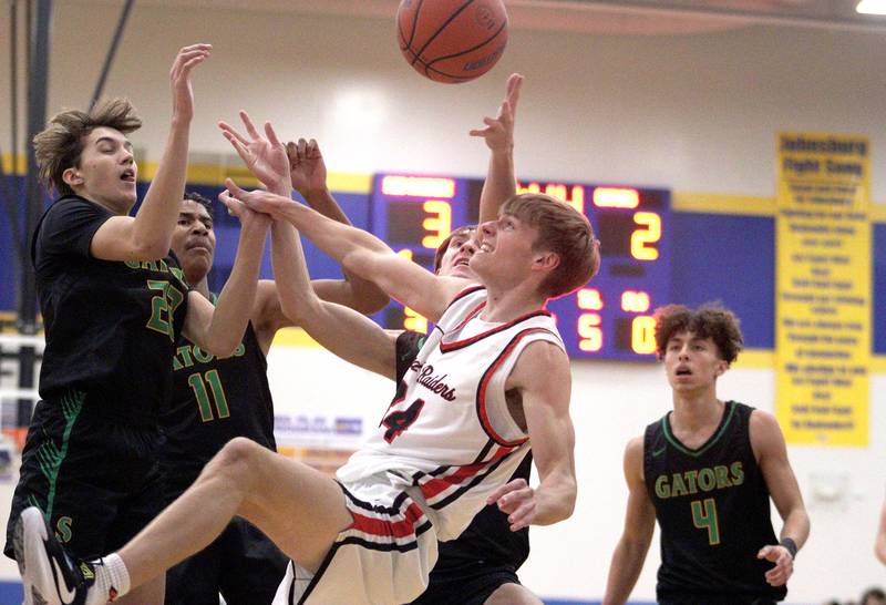 Huntley’s Carter Schaap, center, looks for a rebound against Crystal Lake South in varsity basketball tournament title game action at Johnsburg Friday.