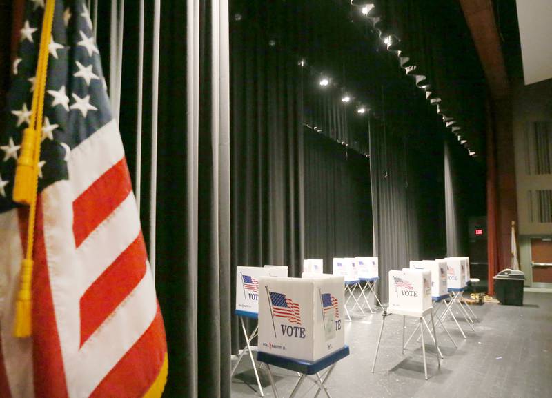 Empty voting booths fill the stage of a polling place on Tuesday, March 19, 2024 at Hall High School in Spring Valley.