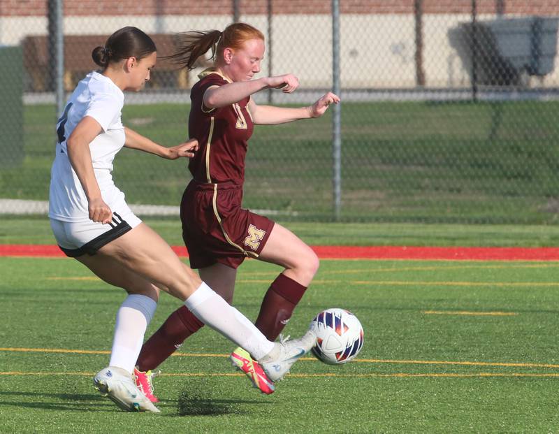 L-P's Abigal Poole kicks the ball ahead of Morris defender Makensi Martin to score a goal during the Class 2A Regional semifinal game on Wednesday, May 15, 2024 at the L-P Athletic Complex in La Salle.