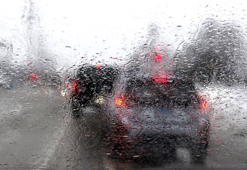 Icy rain gathers on a windshield of a car while traffic wait for the Metro train to go past Walkup Avenue in Crystal Lake on Tuesday, Jan. 23, 2023. Residents throughout northern Illinois woke up to icy and slippery roads.