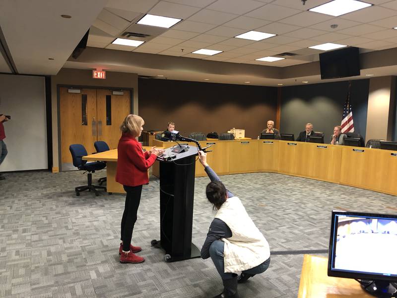 Mary Mauch asked questions about McHenry's anti-bus ordinance at a special council meeting held on Friday, Dec. 29, 2023. Media outlet crews attended the meeting and raced to get Mauch's comments on audio.