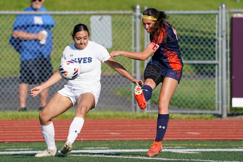 Oswego’s Natalie Braun (right) shoots the ball against Oswego East's Ana Morales (left) during a Class 3A Lockport Regional semifinal soccer match at Lockport High School in Lockport on Wednesday, May 15, 2024.