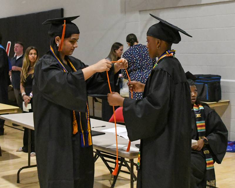 DeKalb High School Senior Class officers Nina De La Cruz (left) and Brooklyn Burks get ready before the start of the 2024 DeKalb High School commencement ceremony on Saturday, May 25, 2024, at the Northern Illinois University Convocation Center in DeKalb.