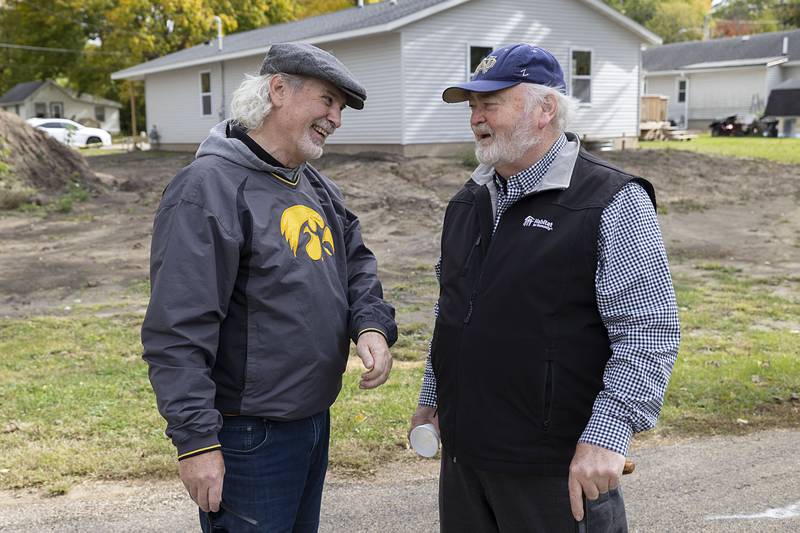 Habitat for Humanity current president Brad Hunsbergerb (left) and first president James Dixon talk about the early days during Sunday’s celebration.