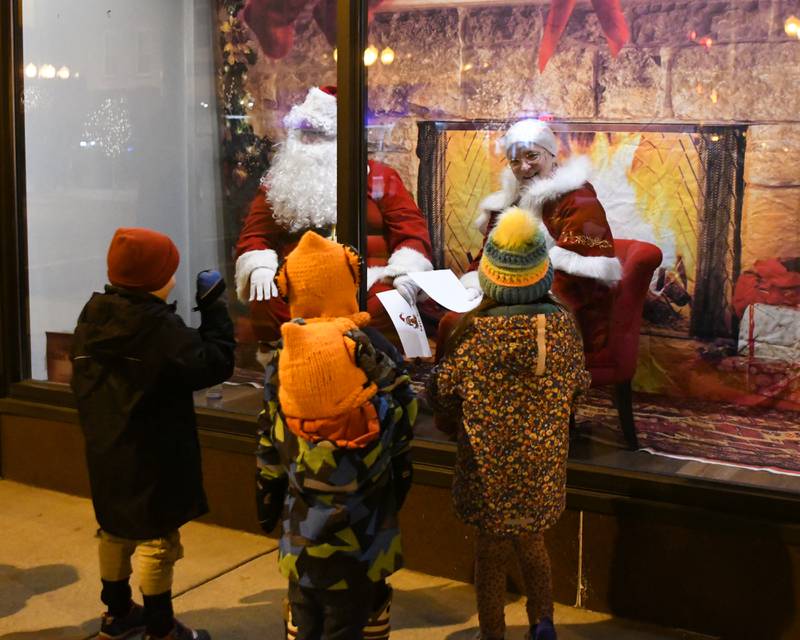 Children greet Santa Claus and Mrs. Claus during the Sycamore Chamber of Commerce's annual Moonlight Magic event held in downtown Sycamore on Friday, Nov. 17, 2023.