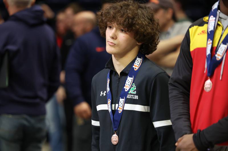 Providence’s Tonny Banas stands on the podium after placing sixth place in the 126-pound Class 2A fitth place match on Saturday, Feb. 17th, 2024 in Champaign.