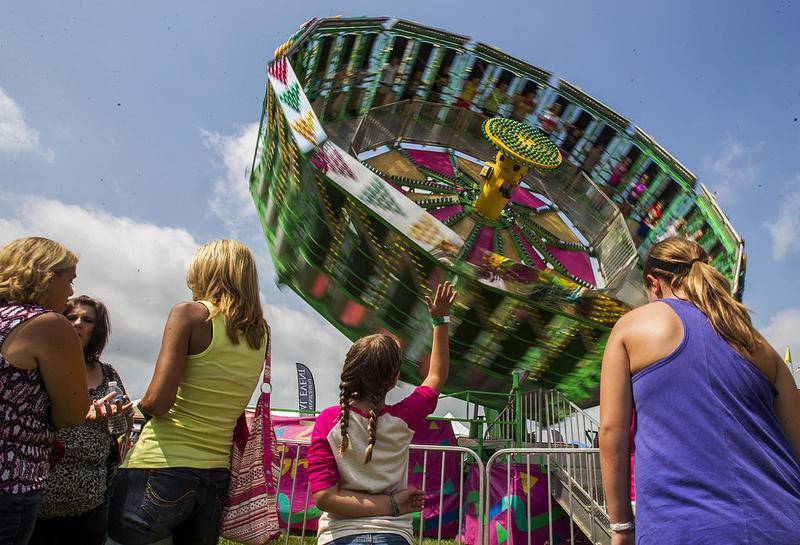 Abbey Kent, 8, of Lake in the Hills (center) waves at friends on the Zero Gravity ride at the carnival September 1, 2013, the last day of the Summer Sunset Festival. As Labor Day symbolizes the end of summer, many spectators come out to enjoy a few more summer activities.