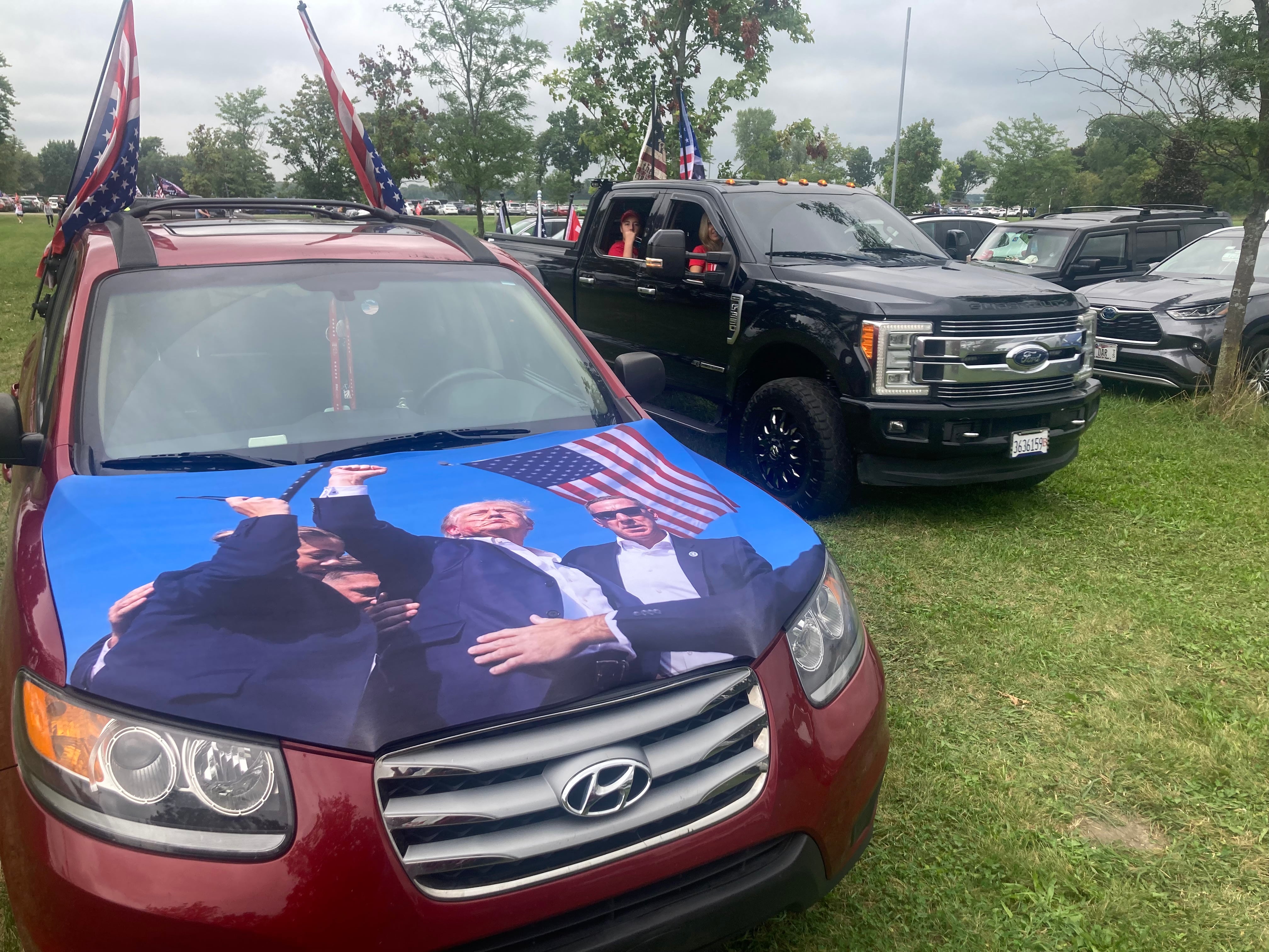 Vehicle decorated with pro-Trump signs arrive at the McHenry County Fairgrounds for a Republican rally on Aug. 18, 2024.