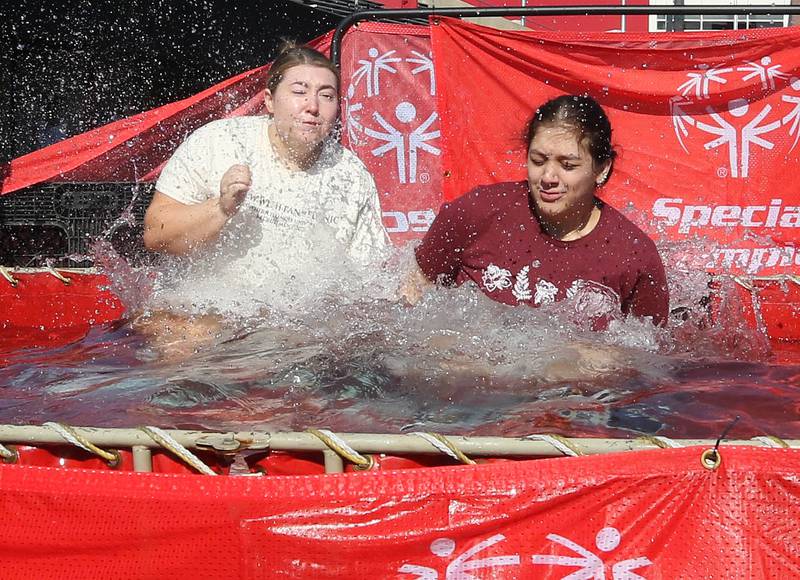 Members of the Alpha Sigma Alpha sorority jump into the water on a cold and windy Saturday, Feb 17, 2024, during the Huskie Stadium Polar Plunge at Northern Illinois University in DeKalb. The Polar Plunge is the signature fundraiser for Special Olympics Illinois.