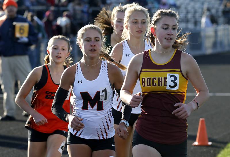 Crystal Lake Central’s Brynn Matthaei (from left to right, McHenry’s Danielle Jensen, and Lynda Rotundo and and Richmond-Burton’s Alexia Spatz compete in the 3200 meter run Friday, April 21, 2023, during the McHenry County Track and Field Meet at Cary-Grove High School.