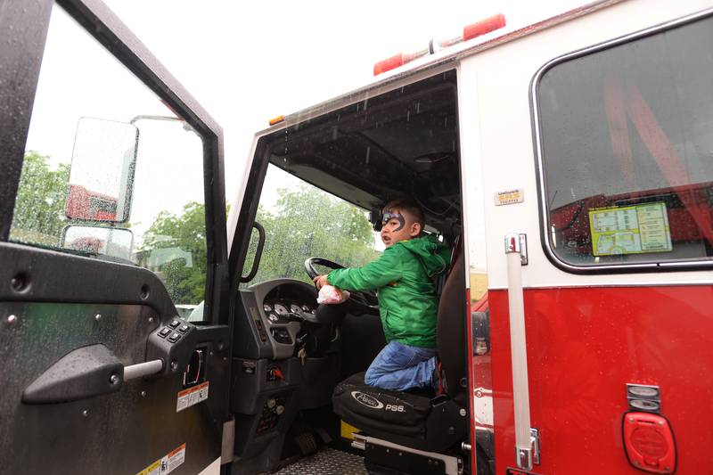 Children including Thomas Clinkenbeard of Winfield enjoy the front seat of a fire truck during the Child Safety Expo held at Lakeview Junior High in Downers Grove Saturday June 1, 2024.