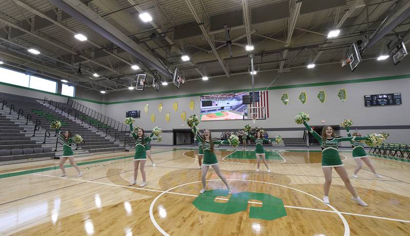 The Seneca High School cheerleaders perform during the open house for the new gymnasium. The gym boasts the largest high school video board in Illinois.