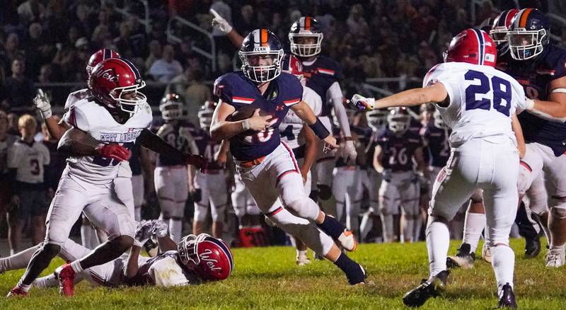 Oswego’s Brett Connolly (16) carries the ball on a keeper against West Aurora during a football game at Oswego High School on Friday, Sept. 29, 2023.