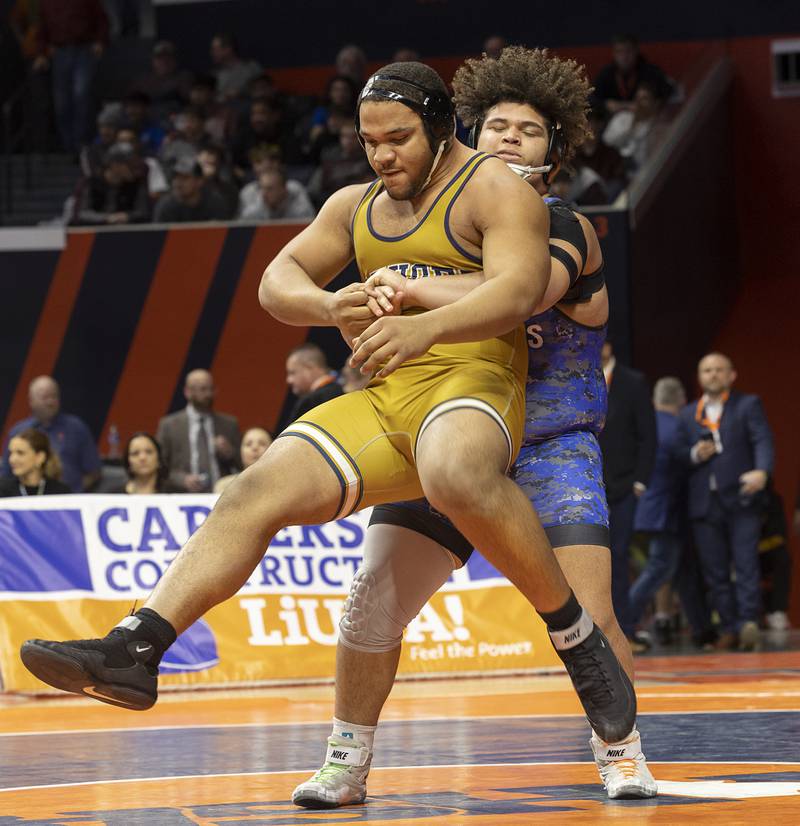 St. Francis’ Jaylen Torres attempts to lift Althoff’s Jason Dowell in the 1A 285 pound championship match Saturday, Feb. 17, 2024 at the IHSA state wrestling finals at the State Farm Center in Champaign.