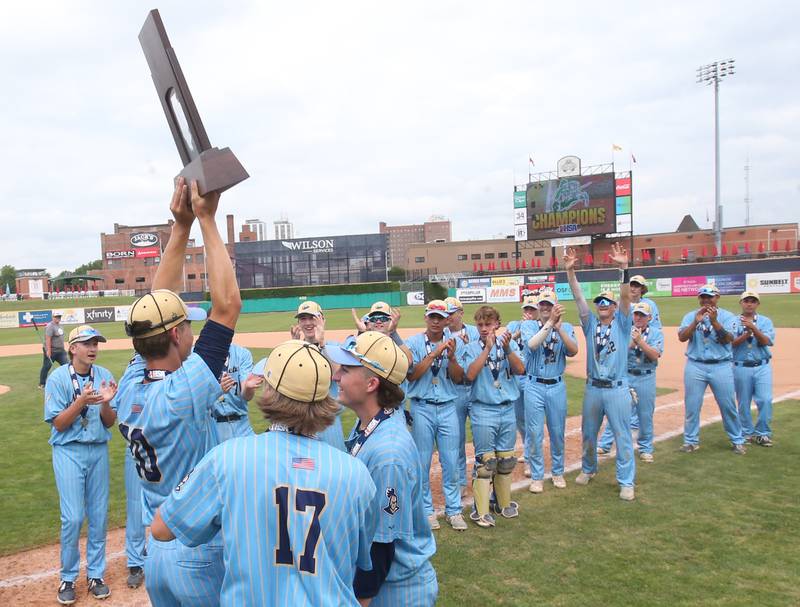 Marquette players Ryan Peterson, Charlie Mullen and Carson Zellers hoist the Class 1A championship baseball trophy after defeating Altamont 6-2 on Saturday, June 1, 2024 at Dozer Park in Peoria.
