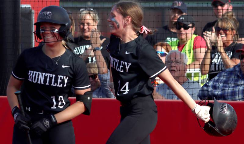 Huntley’s Meghan Ryan, left, and Madison Rozanski are all smiles after Rozanski was called safe at the plate against Barrington in sectional final softball  action at Barrington Friday.