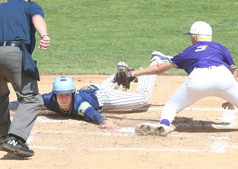 Marquette's Carson Zellers slides safely to score a run as Routt's Brock Runyon misses the tag during the Class 1A semifinal game on Friday, May 31, 2024 at Dozer Park in Peoria.