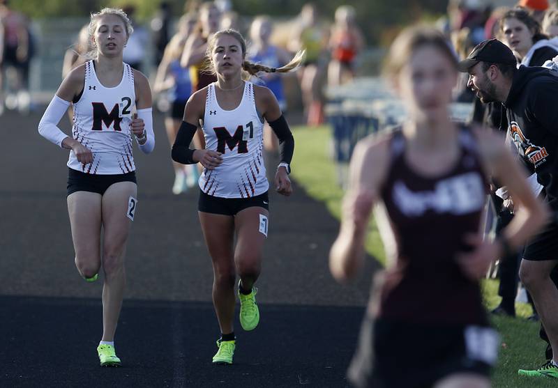 McHenry’s Lynda Rotundo and Danielle Jensen cruise to a one-two finish in the 3200 meter run Friday, April 21, 2023, during the McHenry County Track and Field Meet at Cary-Grove High School.