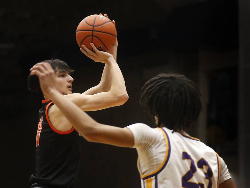 McHenry's Hayden Stone shoots a three-pointer over Hononegah's Darian Tholin during the IHSA Class 4A Guilford Boys Basketball Sectional semifinal game on Wednesday, Feb. 28, 2024, at Rock Valley College in Rockford.