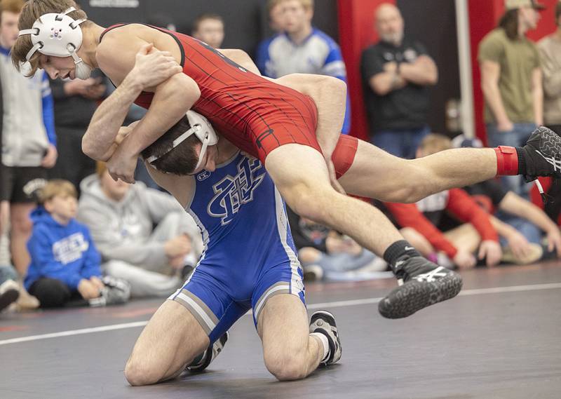 Erie’s Wyatt Goossens goes over top Newman’s Carter Rude in the 144 pound title match Saturday, Feb. 3, 2024 during the class 1A Fulton wrestling regionals.