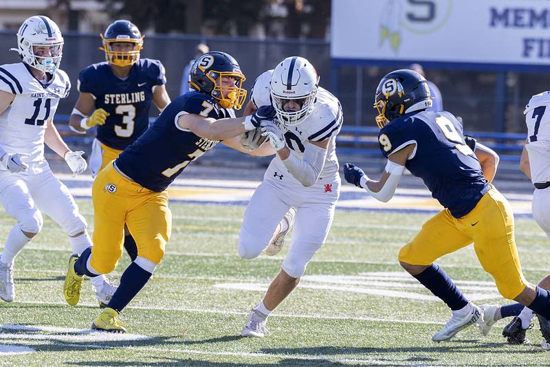 St. Viator’s Ryan Camblin picks up yards against Sterling their first round playoff game Saturday, Oct. 29, 2022.