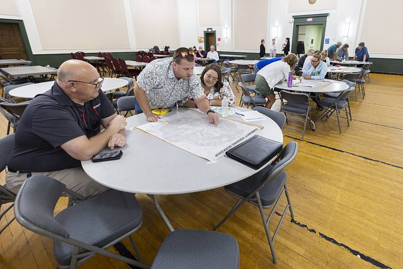 Patrick Moore (left), Ryan Latvaitis and Christine Pomatto look over a map of Dixon Wednesday, Aug. 21, 2024 during a visioning topics meeting.