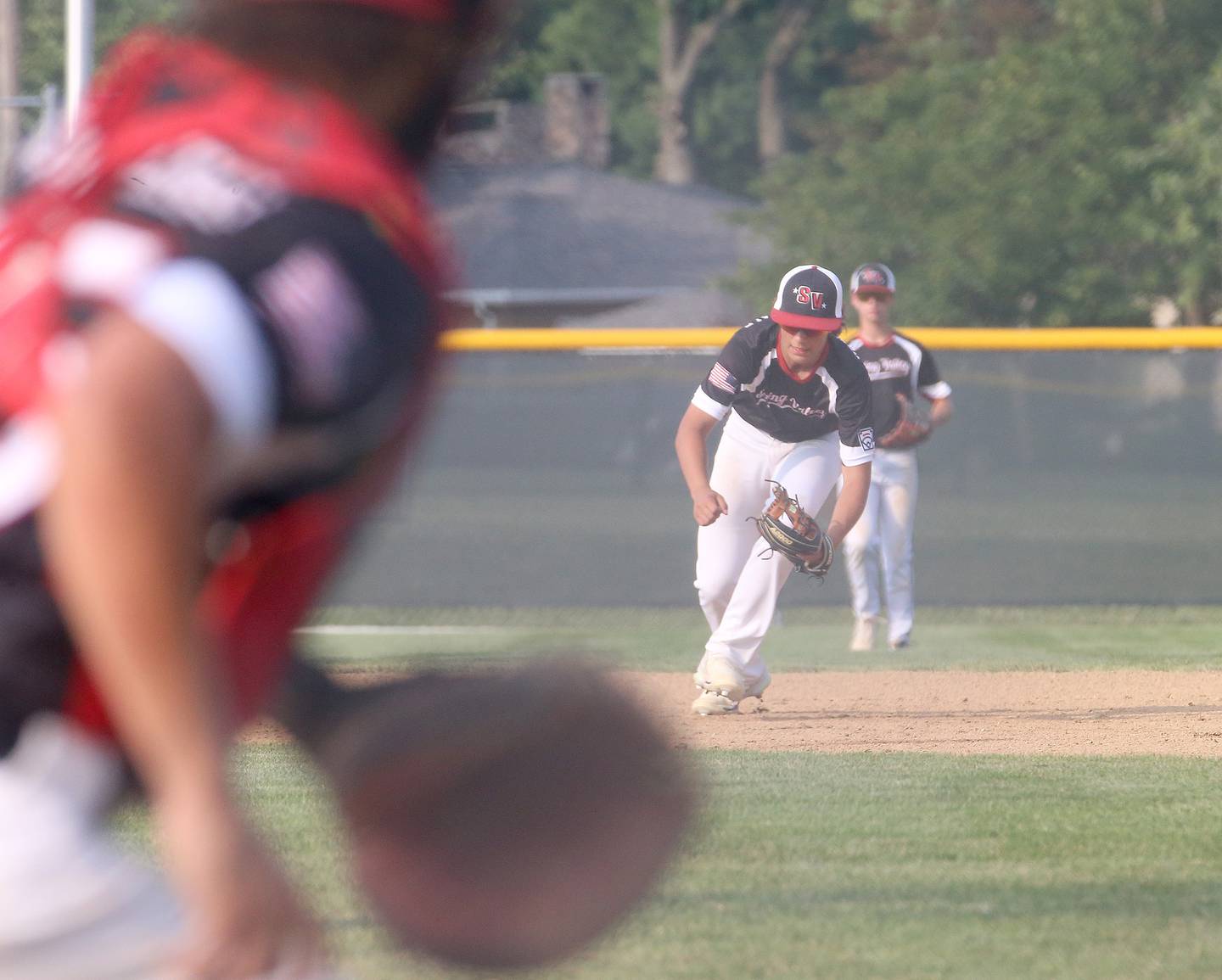 Spring Valley's Geno Ferrari fields a ground ball while playing Michigan during the Central Region Baseball Tournament on Monday, July 24, 2023 at Washington Park in Peru.