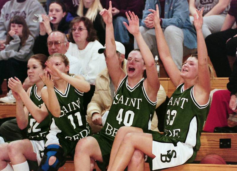 Members of the 2000 St. Bede Lady Bruins (from left) Kristin Racine, Krissa Dinges, Lisa Twardowski, and Katie Zemann celebrate winning the Class 1A Sectional after defeating Rockridge on Feb. 14, 2000 at Bureau Valley High School.