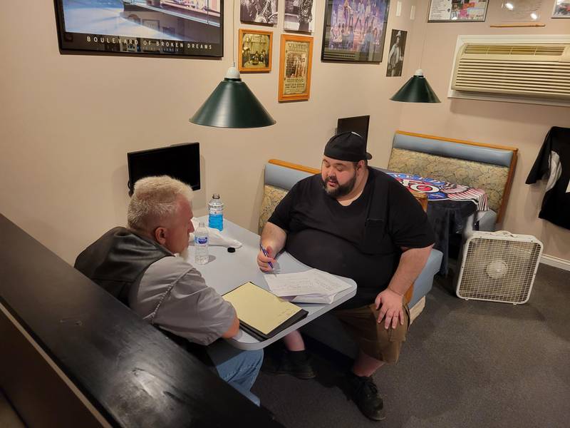 Danny Humphrey, (facing camera), co-writer and director of "Devils Income," goes over lines with Greg Moravec, who plays Ziggy in the film.