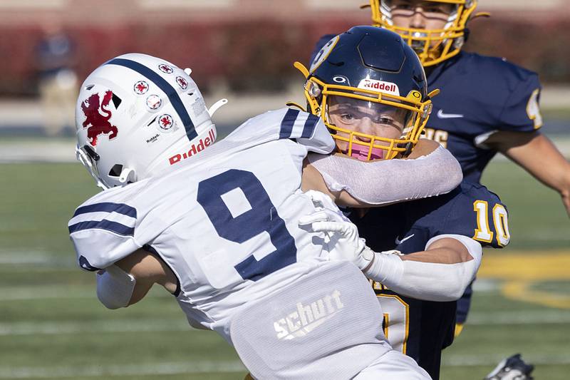 Sterling’s Cole Ledergerber is wrapped up by St. Viator’s Patrick Bauer in the first round playoff game Saturday, Oct. 29, 2022.