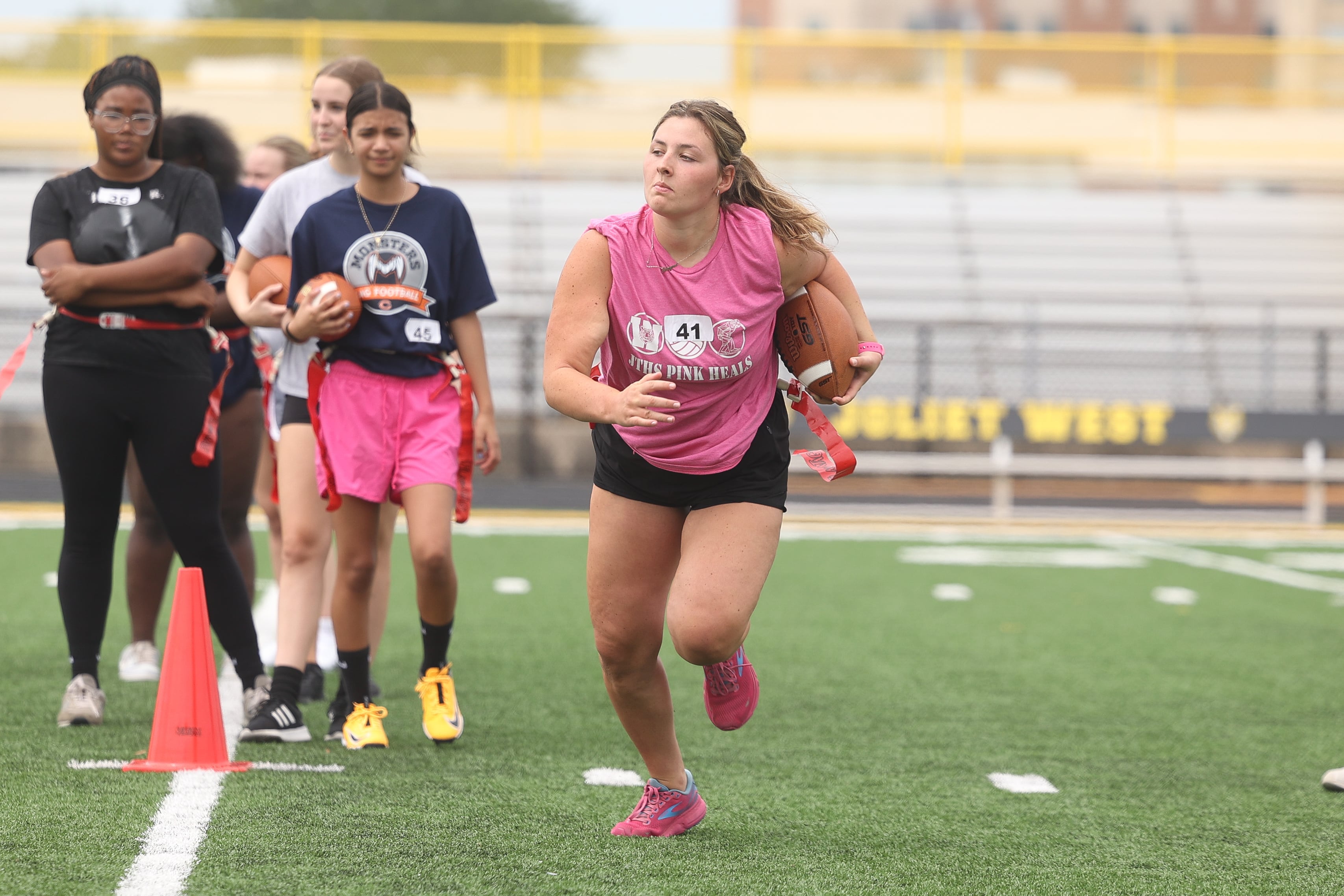 Alayna Ardaugh runs a drill during Joliet West’s girls flag football tryouts on Monday, Aug. 12, 2024 at Joliet West High School.