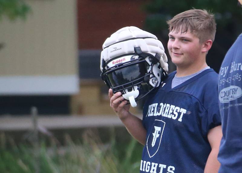 Fieldcrest's Jordan Carey smiles while takes a break during football practice on Monday, July 8, 2024 at Fieldcrest High School.