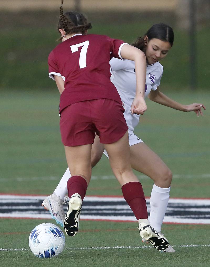 Hampshire's Chelsea Martinez tries to kick the ball away from Prairie Ridge's Grace Turman during a Fox Valley Conference soccer game on Tuesday, April 16, 2024, at the MAC Athletic Complex in Crystal Lake.