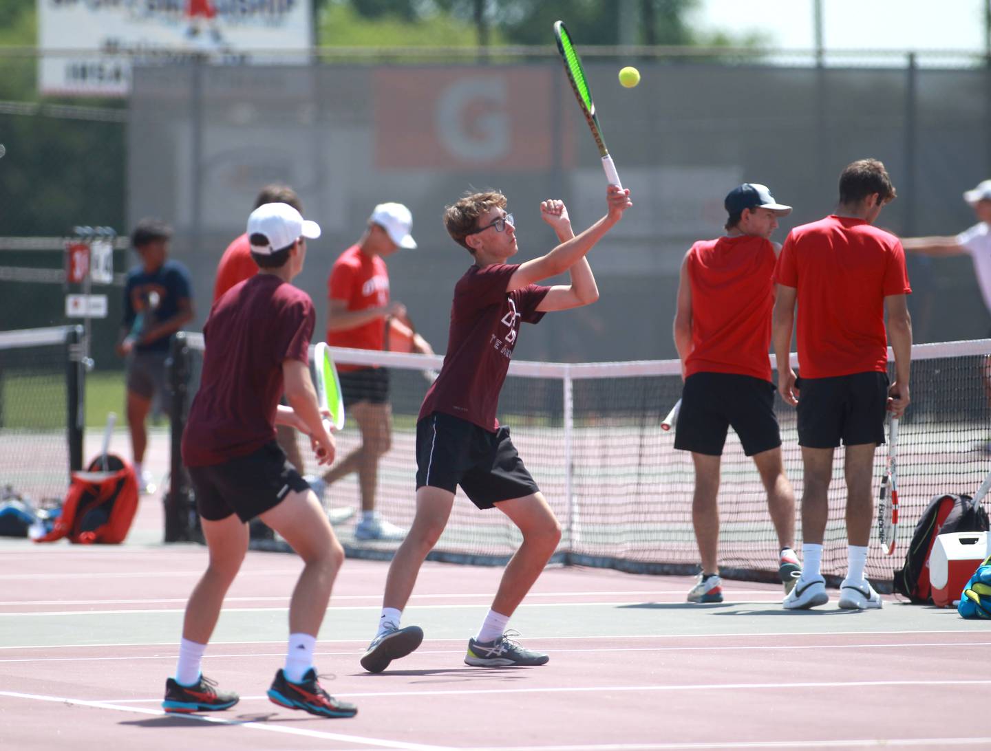 Prairie Ridge’s Tim Jones returns the ball during a doubles match with partner Cole Palese (left) in the state championship preliminaries at Palatine High School on Thursday, May 23, 2024.