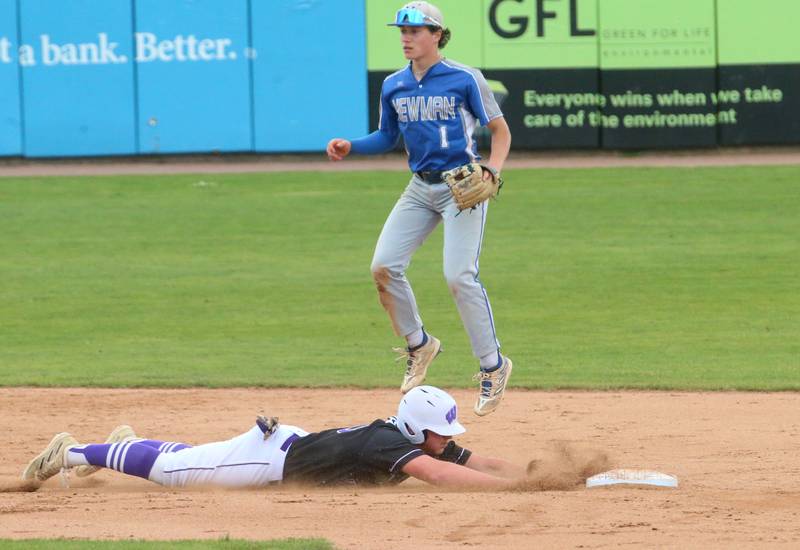 Newman's Garret Matznick watches the throw go over his head as Wilmington's Reid Juster slides safely back to second during the Class 2A third place game on Saturday, June 1, 2024 at Dozer Park in Peoria.