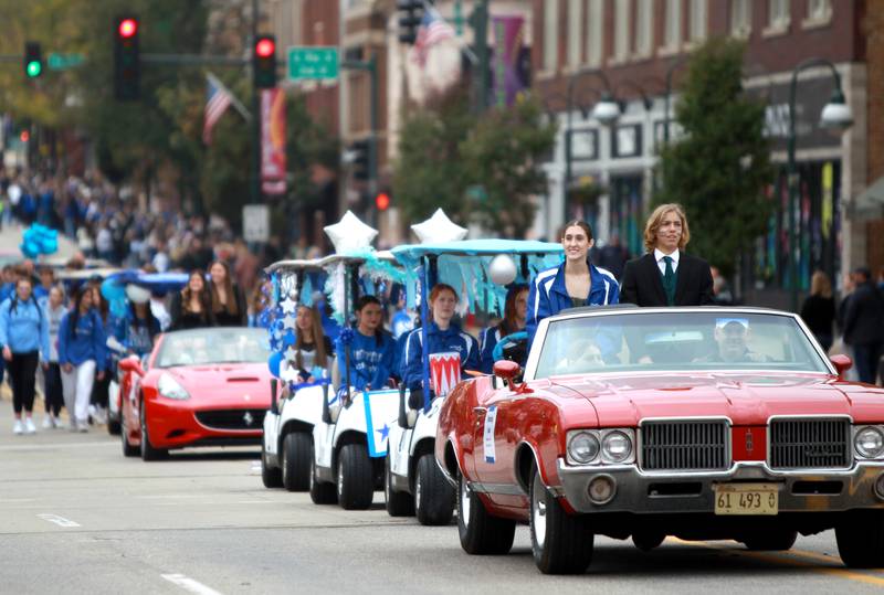 St. Charles North’s Stephen Lynch and Marissa Swierkosz represent the marching band during the school’s annual homecoming parade on Main Street through downtown St. Charles on Thursday, Oct. 19, 2023.