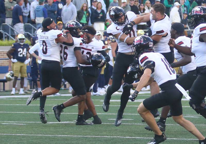 Members of the NIU football team celebrate after beating Notre Dame on Saturday, Sept. 7, 2024 at Notre Dame Stadium.