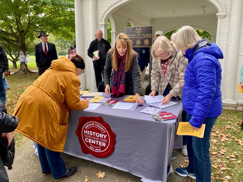 Michelle Donahoe, executive director of the DeKalb County History Center (second from left), signs members of the public in to the DeKalb County History Center’s annual Etched in Stone Cemetery Walk at Elmwood Cemetery, 901 S. Cross St., Sycamore on Sunday, Oct. 8, 2023.